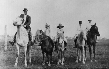 E. On horses (Caption 'In 1922')