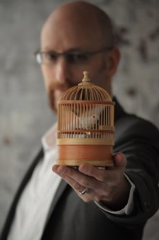 David Smooke with a tiny birdcage